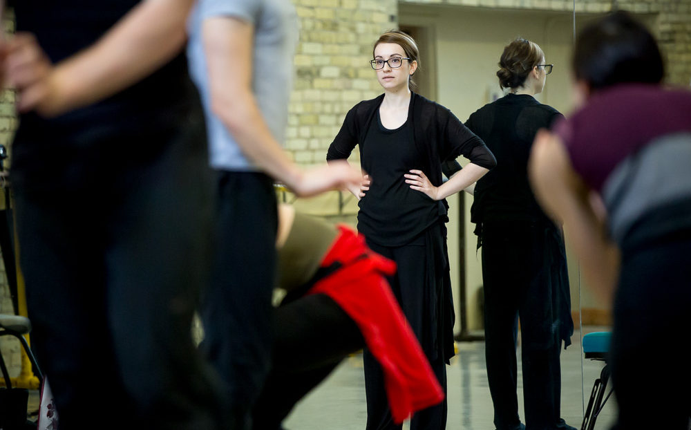 Mariana Oliveira working with dancers in the studio.