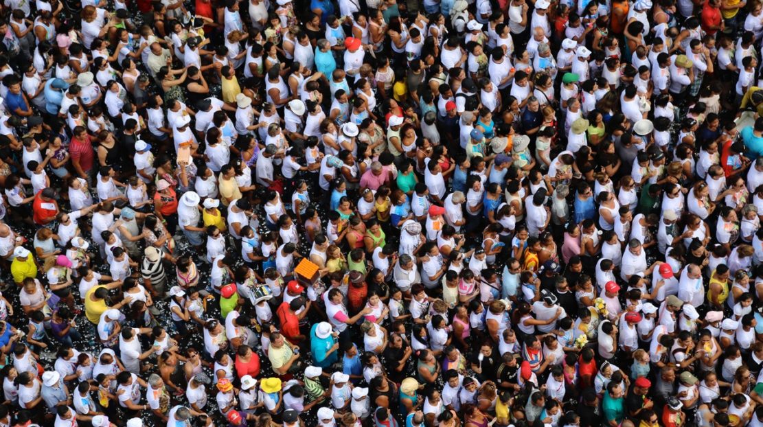 Aerial shot of many people packed into a crowded space.
